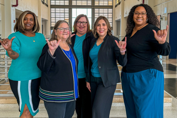 LT and the four Associate Deans stand in the Student Union for Teal Tuesday